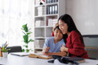 © Phimwilai - Asian mother encouraging son doing homework at home