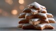 © fotogurme - Stacked gingerbread stars with glistening icing evoke cozy Yule celebrations and whimsical wonderland feasts amid ambient twinkle lights