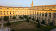 facade arch historical centre hospitalier universitaire of Bordeaux saint andre french university interior building garden courtyard of historic hospital in france city