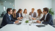 © Ideova.ai - Blurred background of business meeting at office table with businessmen and businesswomen discussing project, collaborating, working on computers, teamwork, communication, and professional corporate