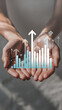 © ZoiaS - Hands Holding Growing Business Graph with Arrows