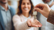 © Ali - Keys handed to smiling couple signify new home ownership