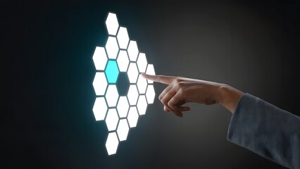 Wall Mural - A hand interacts with an array of illuminated hexagonal tiles on a dark backdrop, representing modern technological interactions. 