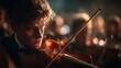 © Praphat - Young violinist performing in dramatic concert setting, focused expression