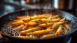 © creative - French fries frying in bubbling hot oil