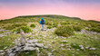 © Hq Visual Studio - Man hiking across rocky limestone landscape at  The Burren in County Clare Ireland during colourful sunset sky