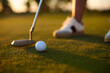 © Drazen - Close up of golfer taking shot at sunset.