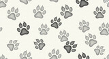 Repeating pattern of gray paw prints on a light beige background, suggesting a playful, animal-themed design, ideal for textile or digital print