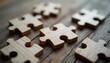 © Viktor - Wooden puzzle pieces scattered on rustic wooden surface suggest collaboration, teamwork, problem-solving. Image process of building something together, finding solutions, achieving shared goals