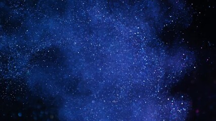 Wall Mural - swirling blue and purple glitter dust creates a seamlessly looping cosmic abstract background glitte