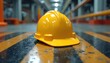 © Pete - Yellow hard hat rests on safety barrier stripes. Close-up shows plastic texture and reflective surfaces. Construction site safety equipment. Industrial work environment.