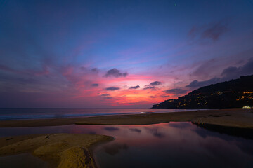 Wall Mural - sweet sky at sunset reflection in the beach puddle. The sun's rays glistened in the puddle creating a mesmerizing dance of colors. stunning colorful reflection in sea surface.colorful sky
