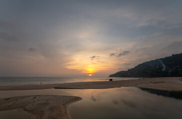 Wall Mural - sweet sky at sunset reflection in the beach puddle. The sun's rays glistened in the puddle creating a mesmerizing dance of colors. stunning colorful reflection in sea surface.colorful sky