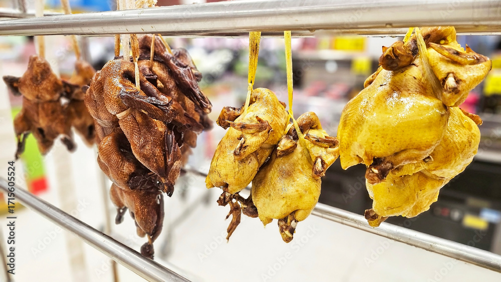 Duck Hanging Racks Duck and chickens hanging on a display rack in a market, showcasing ...