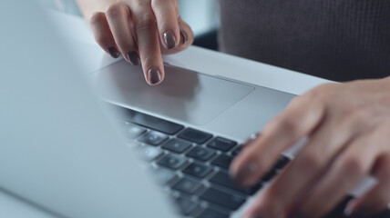 Wall Mural - Close up of business woman hands working, typing on laptop computer keyboard, surfing the internet on office desk, online working, telecommuting, freelance at work