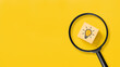 © Achmad Khoeron - Creative idea concept, magnifying glass and light bulb icon on wooden block with yellow background