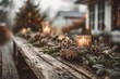 © woters - Rustic wooden table has candle, pine cones and evergreen boughs set for the holiday season.