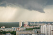 Dark storm clouds over urban landscape and residential and commercial buildings. rain in the city