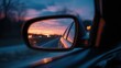 © Punnn - Sunset Journey: The car's side mirror reflects the scenic beauty of the sunset as it drives along the open road. It depicts the beauty of time passing.