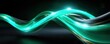 © Thamonchanok - Glowing light blue and green lines background concept. A dynamic wave of glowing green light creating an abstract design.