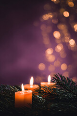 Wall Mural - A beautiful, bright, festive Christmas abstract purple background with lit candles and a bokeh effect. Shining and sparkling, vibrant. Vertical banner, copy space