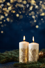 Wall Mural - A beautiful, bright, festive Christmas abstract blue background with lit candles and a bokeh effect. Shining and sparkling, vibrant. Vertical banner, copy space