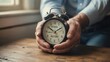 © Habibur614 - Hands holding vintage alarm clock showing the transition from work to retirement concept