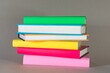 © Banana Photography - A pile of colorful books on a table illustrate reading, literature, learning, education and knowledge.