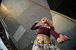 © Seventyfour - Caucasian girl dancing outdoors under urban structure, looking confident with expressive body language, wearing casual streetwear, representing Gen Z youth culture