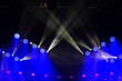 © Светлана Лазаренко - A stage with multiple blue and red lights is lit up. The blue lights are positioned on the left side of the stage, while the red lights are on the right side