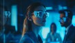 © Studicon - The illustration shows a woman in a dark blue suit and transparent AR glasses, viewing data projected onto the glasses in a dark, modern office setting with colleagues visible in the background.