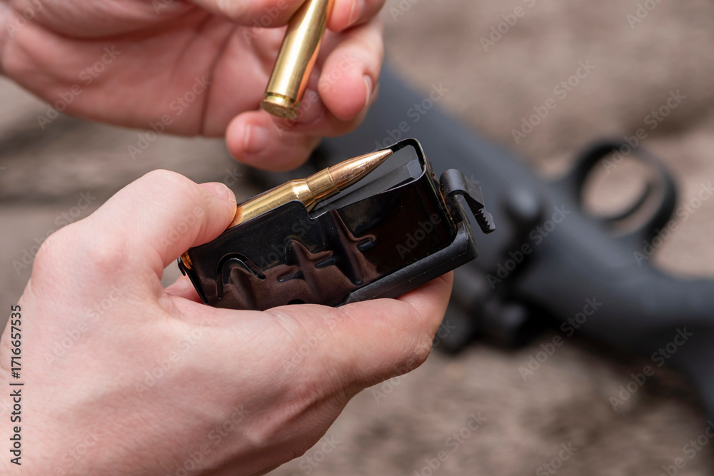 Ammunition for a rifle with a magazine, loading combat weapons. A man ...