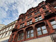 Historic red brick building on Manchester street shows ornate architecture and urban charm