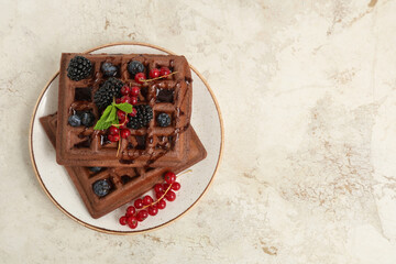 Wall Mural - Plate of sweet chocolate Belgian waffles with fresh berries and mint on white background