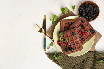 Wall Mural - Plate of sweet chocolate Belgian waffles with fresh berries and mint on white background