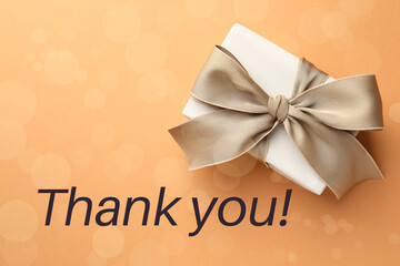 Wall Mural - Thank you card design with gift boxes on pale orange background, bokeh effect