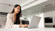 © fizkes - Beautiful young executive woman working on company online project