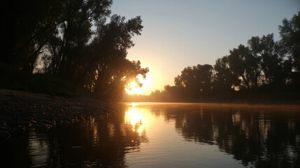 Wall Mural - serene sunrise over calm river, with mist rising from water and silhouettes of trees lining banks. w