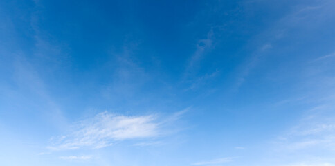 Wall Mural - A bright blue morning sky with a few clouds and sunlight for nature background.