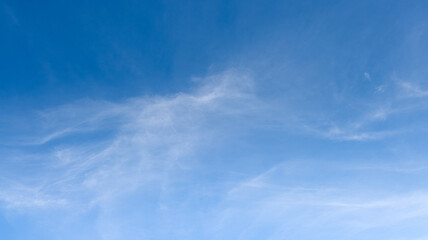 Wall Mural - A bright blue morning sky with a few clouds and sunlight for nature background.
