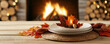 © Anucha - cozy dining setting with autumn leaves, a woven placemat, and a warm fireplace in the background, creating a welcoming atmosphere.