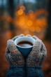 © spyrakot - Cozy Hands in Knitted Gloves Holding Warm Beverage in Autumn