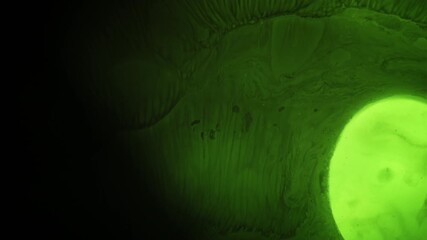 Wall Mural - Ripple ink. Emulsion art. Defocused green neon color blob liquid water paint drop dark black flow spreading on light abstract texture.
