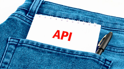 API (application program interface). The concept of technology and development. Phrase, words, text API a hint on a piece of paper from your pocket.