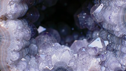 Detailed close-up of a sparkling amethyst geode, displaying its purple crystal formations, a beautiful mineral with a natural and vibrant aesthetic.