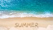 © Sogon - High-angle view of the word 'SUMMER' written in the sand on a beach