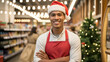 © KHUKI - Smiling Store Clerk in Santa Hat Stands Proudly in Aisle Ready to Help Holiday Shoppers