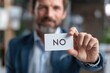 © Best Wishes Art - A Businessman Holding a 'No' Card, Expressing Disagreement or Refusal in a Professional Setting