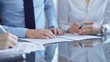 © volha_r - Business people are reviewing a contract and discussing the terms of the agreement. Lawyers at work