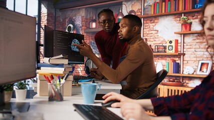Team of startup workers conducting code review on PC to fix bugs, identifying technical issues with artificial intelligence company software. IT staff members optimizing code using device, camera A